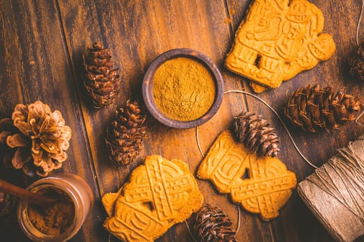 Gingerbread spice mix and seasoning for gingerbread cookies for Christmas on wooden background