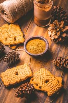Gingerbread spice mix and seasoning for gingerbread cookies for Christmas on wooden background