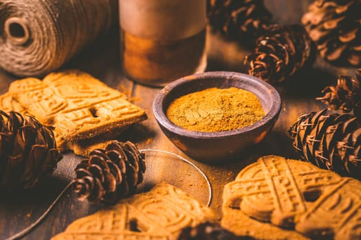 Gingerbread spice mix and seasoning for gingerbread cookies for Christmas on wooden background
