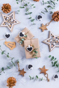 Holiday Christmas Gifts with Boxes, Coniferous, eucalyptus and ornaments on snowy background