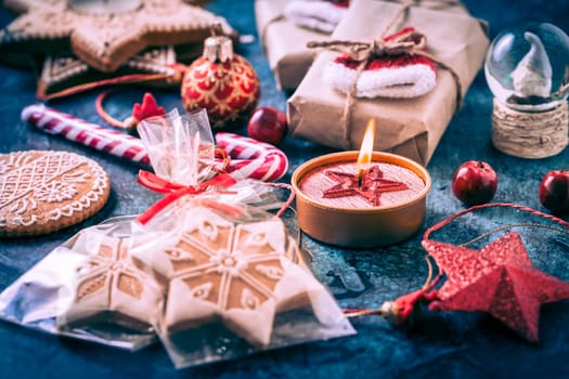 Holiday Christmas Gifts with Boxes, Candle and gingerbread cookies on dark blue background