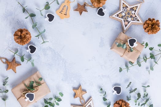 Holiday Christmas Gifts with Boxes, Coniferous, eucalyptus and ornaments on snowy background
