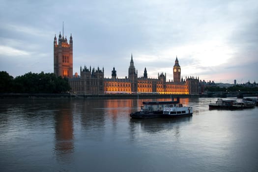 The River Thames boats and Parliament at dusk
