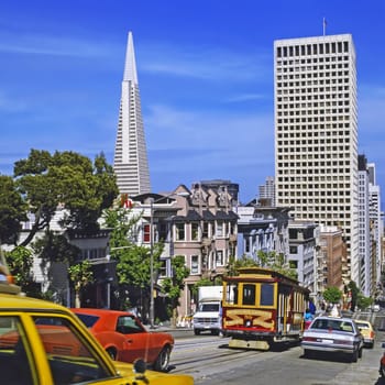 Street with cars and cable car in San Francisco, California
