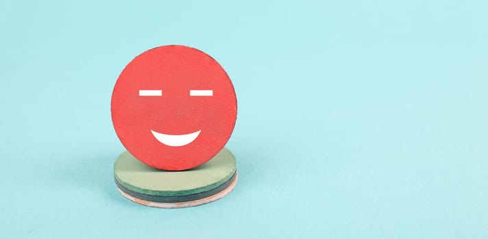 Smiling face, blue colored background, copy space, rating, positive feedback, customer experience, happy emotion