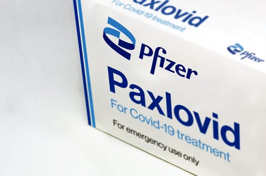 New York, USA, November 2021: Pfizer Covid-19 Paxlovid treatment box isolated on a white background. Health and prevention.