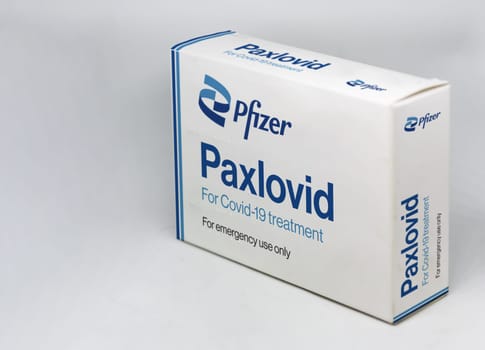 New York, USA, November 2021: Pfizer Covid-19 Paxlovid treatment box isolated on a white background. Health and prevention.