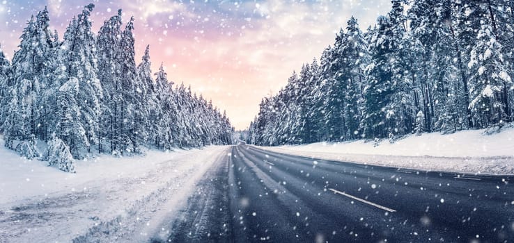 Beautiful view of the winter curve country road in snowstorm. Wavy snowy way in natural park.