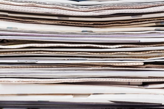 Stack of newspapers closeup shot. News and updates concept.