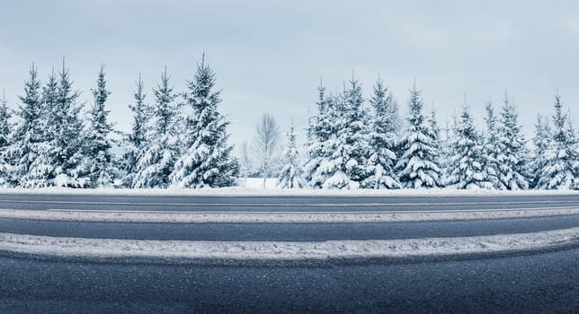 Panoramic view of the beautiful country road in winter. Panorama of snowy way in natural park.