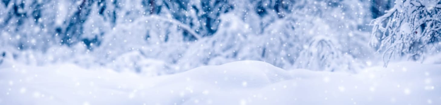 Snowy background with closeup view of the wavy snowdrifts in snowfall. Concept of the wallpaper, background and backdrop.