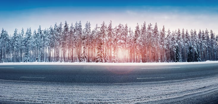 Panoramic view of the beautiful country road in winter. Panorama of snowy way in natural park.