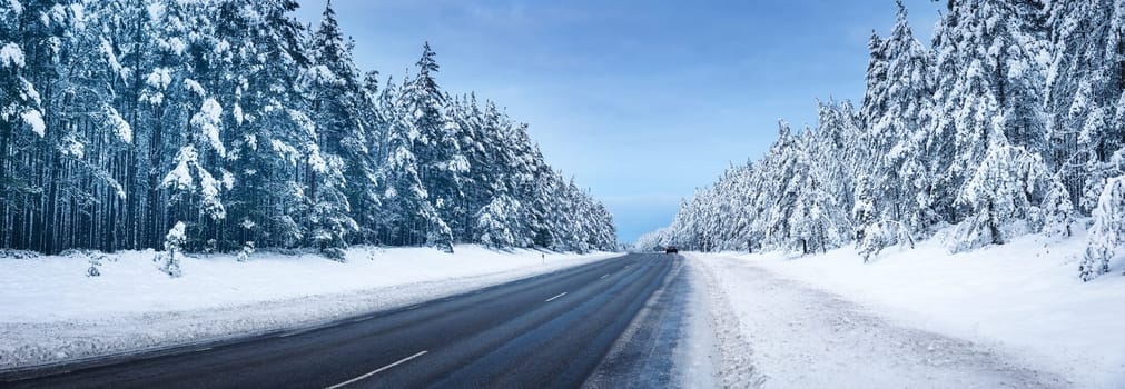 Panoramic view of the beautiful country road in winter. Panorama of snowy way in natural park.