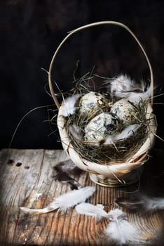 Easter eggs in basket on wooden background