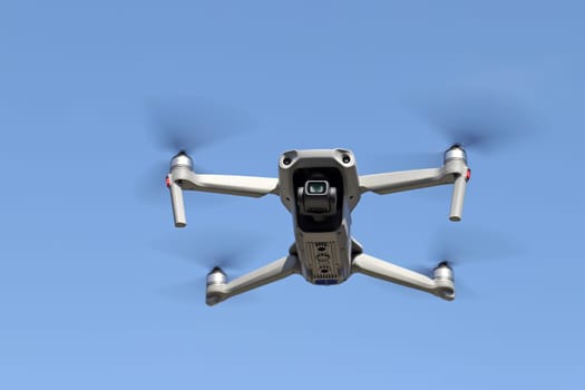drone flying in air and clear blue sky background