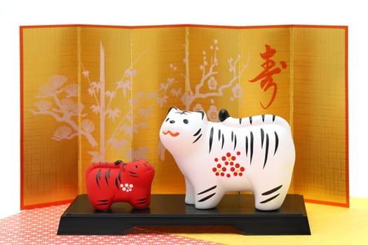 Dolls of Tora Tiger. Japanese new year card. Japanese new year tiger object. Japanese word of this photography means "congraturations"""