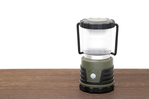 Photo of a led lantern for camping on a wooden table