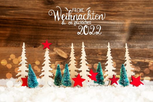 Christmas Trees With German Frohe Weihnachten Und Ein Glueckliches 2022 Means Merry Christmas And Happy 2022. Decoration Like Red Star. Rustic Brown Wooden Background With Snow And Bokeh Effect