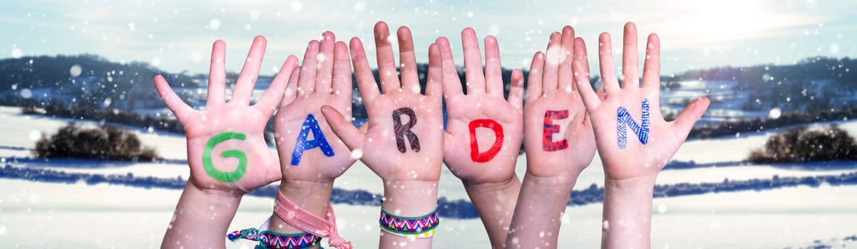 Children Hands Building Colorful English Word Garden. Snowy Winter Background With Snowflakes