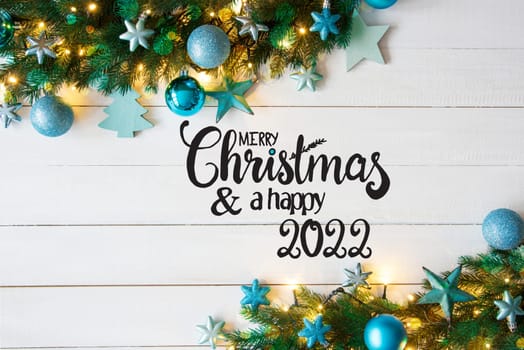 Turqouise Christmas Decoration With English Calligraphy Merry Christmas And A Happy 2022. Fir Tree Branch Border With Shiny Fairy Lights