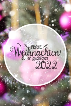 German Calligraphy Frohe Weihnachten Und Ein Glueckliches 2022 Means Merry Christmas And Happy 2022. Christmas Tree With Blurry Pink Christmas Ball Ornament And Snowflakes
