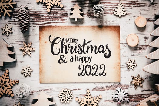 Old Paper With English Calligraphy Merry Christmas And Happy 2022. Vintage White Wooden Christmas Decoration Like Tree
