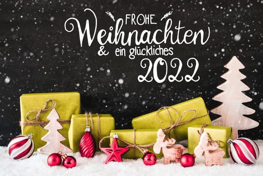 German Calligraphy Frohe Weihnachten Und Ein Glueckliches 2022 Means Merry Christmas And A Happy 2022. Green Christmas Present With Decoration Like Reindeer And Ball. Black Background With Snowflakes