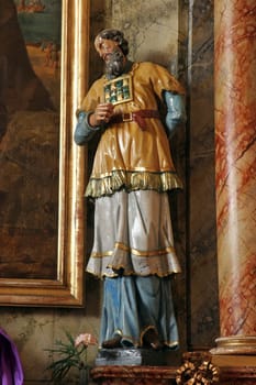 Statue of Saint on the main altar in the Church of St. John the Apostle and Evangelist in Cerje, Croatia