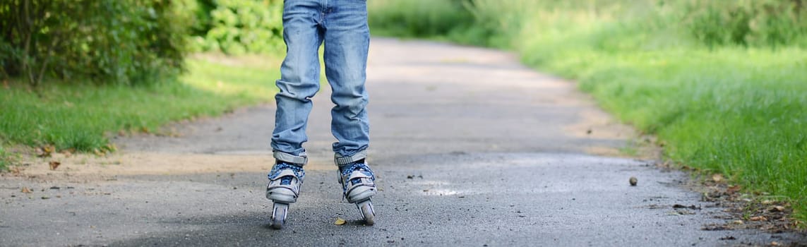 Inline Skating child, learning a new sport activity, outdoor, summertime