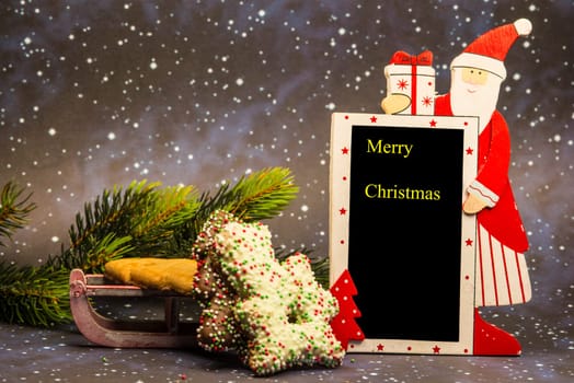 Santa Claus with Merry Christmas blackboard