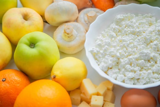 Fruits, vegetables and dairy products lie next to each other. . High quality photo