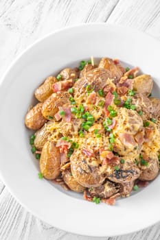 Golden potatoes topped with smoky bacon, gooey cheddar, and fresh green onion