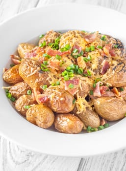 Golden potatoes topped with smoky bacon, gooey cheddar, and fresh green onion
