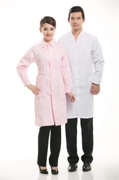 Staff wear coats in front of white background