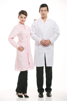 Staff wear coats in front of white background