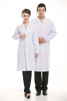Staff wear coats in front of white background