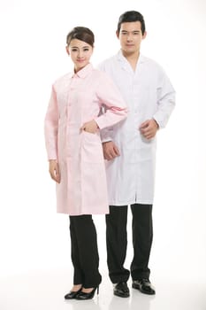 Staff wear coats in front of white background