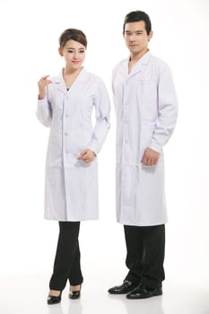 Staff wear coats in front of white background