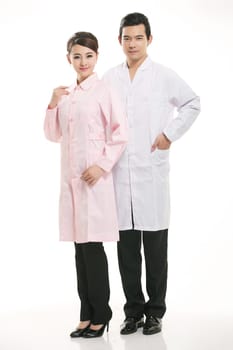 Staff wear coats in front of white background