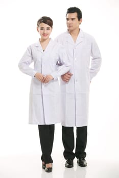 Staff wear coats in front of white background