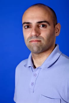an casual young man portrait over a blue background
