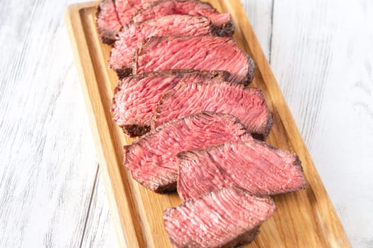 Tender fillet mignon steak, perfectly cooked, sliced, and elegantly presented 