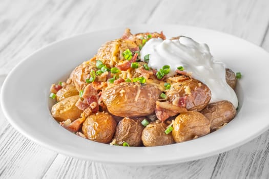 Golden potatoes topped with smoky bacon, gooey cheddar, and fresh green onion