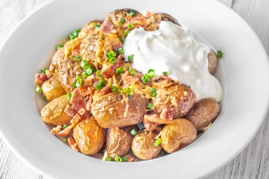 Golden potatoes topped with smoky bacon, gooey cheddar, and fresh green onion