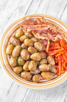 Golden potatoes, smoky bacon, and roasted peppers create a savory, flavorful dish