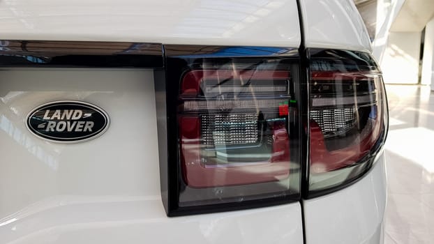 Ukraine, Kiev - March 27, 2020: Land Rover Discovery Sport shiny modern white car at the exhibition. Body, headlights close-up, rear and front view, chrome grille, car logo