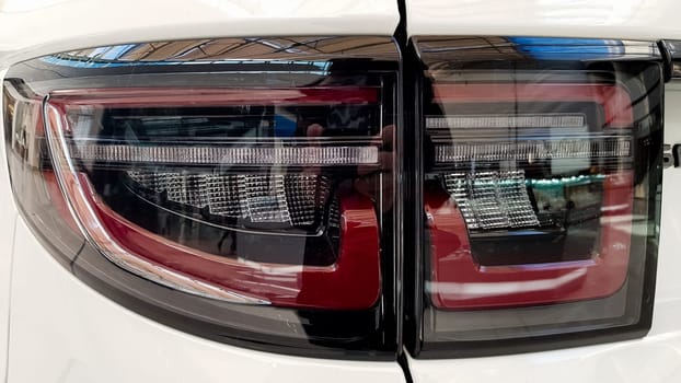 Ukraine, Kiev - March 27, 2020: Land Rover Discovery Sport shiny modern white car at the exhibition. Body, headlights close-up, rear and front view, chrome grille, car logo