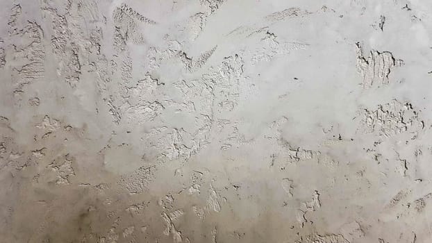 Gray abstract background. Beautiful gray textured stucco on the wall. Background from gray stucco