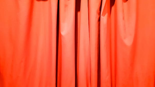 Red curtain use for background. Silk Cloth Background, Red Satin Fabric Waves, Abstract Texture. Red concert curtain full of folds.