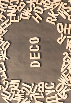 Deco Word In Wooden Cube Alphabet Letters Top View On A rustic paper Background.